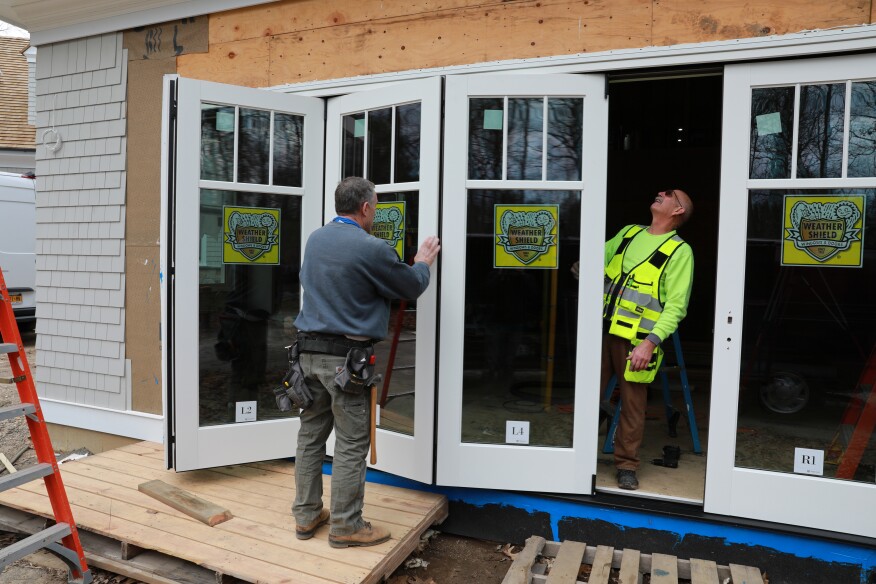 When all the panels are installed, the author (at right) checks the alignment and adjusts as needed.