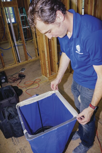 The Alnor flow hood measures airflow through a supply register.