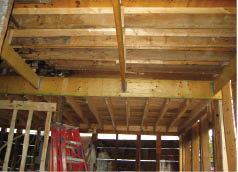 A new 14-inch LVL beam, inserted below the existing second-story joists, spans the 24-foot-wide kitchen ell.