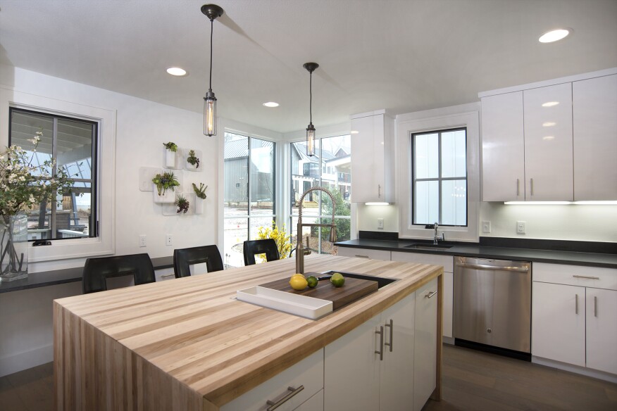 The kitchen features butcher-block surfaces.