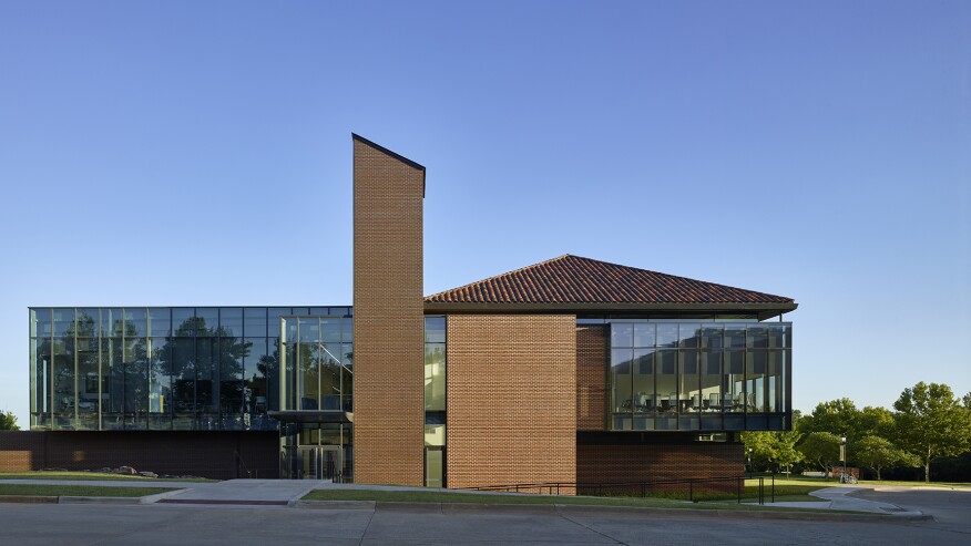 The north elevation illustrates the intersection of the dual facades as the traditional masonry and clay tile roof on the west begins to transition to zinc cladding and glass on the east.