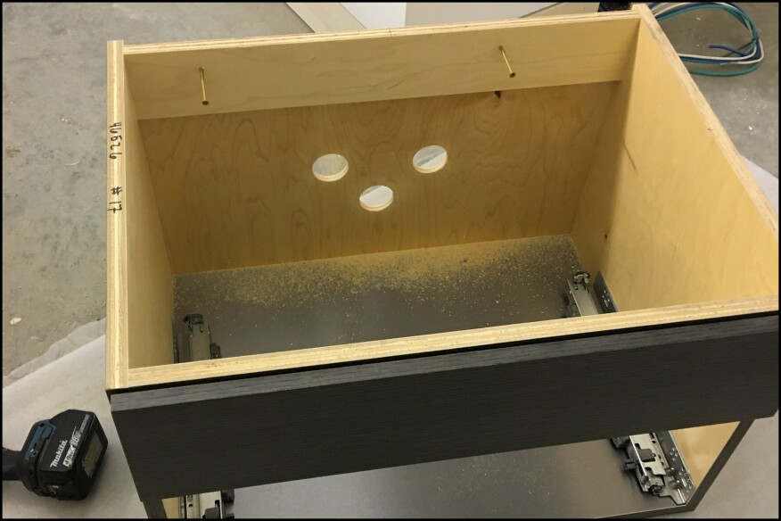 Here, the holes for the supply lines were cut larger to accommodate shut-off valves installed on the stub-outs; valves are typically installed after the cabinet installation.