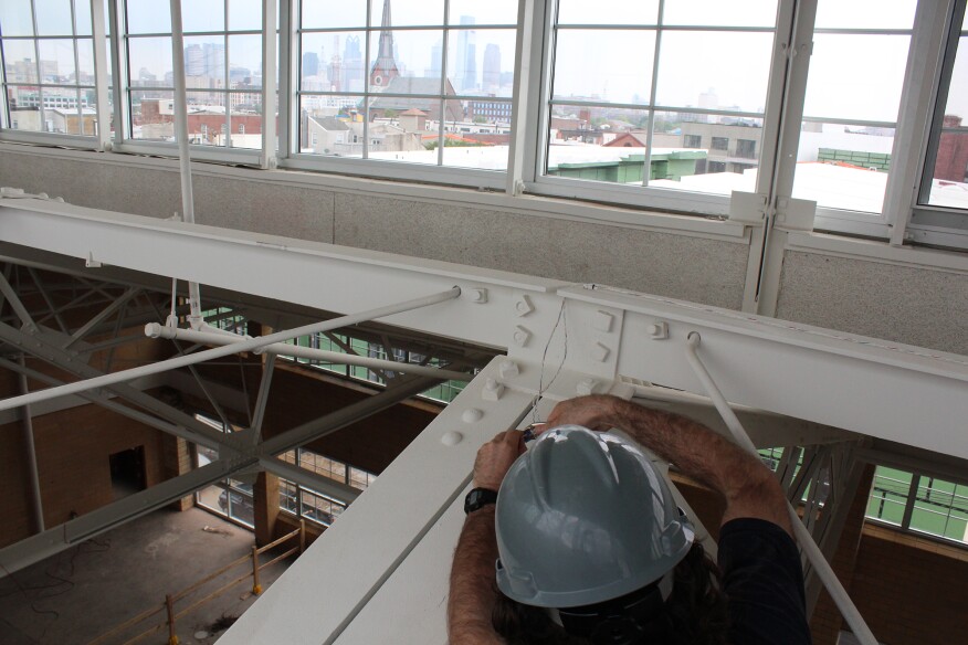 A worker installing a sensor in the KT office