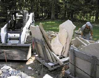 Less expensive than geometrically cut stone pavers, randomly sized and shaped flagstones are shipped to the job site standing up on pallets.