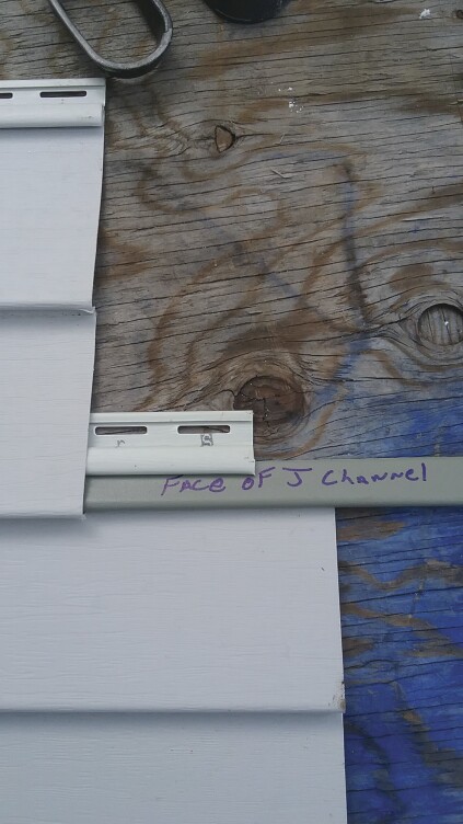The second method is cutting the face off J-channel and inserting it into the locking strip of the lower panel.