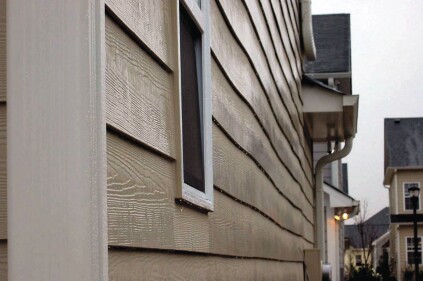 Exterior sheathing can buckle when it dries. Plywood, OSB and fiber board are all affected, and the the defect telegraphs to the siding. Photo: Steve Easley