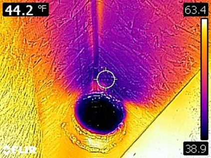 A thermal image of the same vent taken during a final blower door test shows leakage that will increase test results.