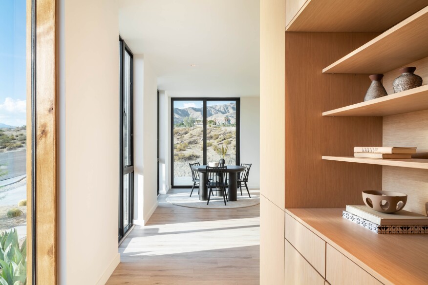 The utility core is clad in white oak and includes built-in cabinets and display shelving.