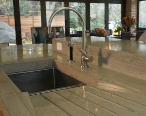 A highly flexible material, concrete can be used to create colorful countertops with a variety of planes and surfaces. This top by Sean Dunston has integrated drainboards set right into the top.