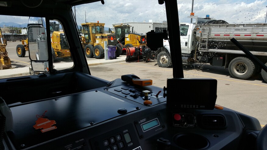 The “little black box” mounted to this refuse truck’s windshield captures video only when something unusual, like a hard swerve, sudden brake, or collision, happens. The video clips are uploaded to the DriveCam Risk Analysis Center, where they undergo human review and are transferred to the City of Denver Public Works Solid Waste Management Division with data that supervisors use to coach drivers.
