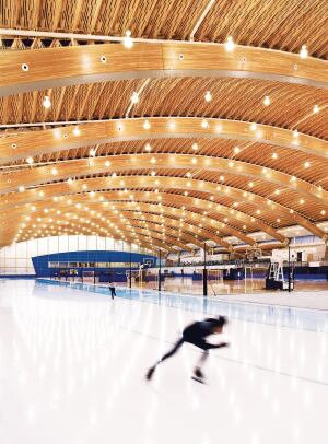 The roof of the Richmond Oval is made up of large Douglas fir glulam arches, with ribbed panels made from recovered wood devastated by a pine beetle infestation in the interstitial spaces.