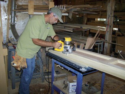 A router with a flush trim bit takes off the excess material. A little sanding, and the joint between the sides and face frame becomes almost invisble.