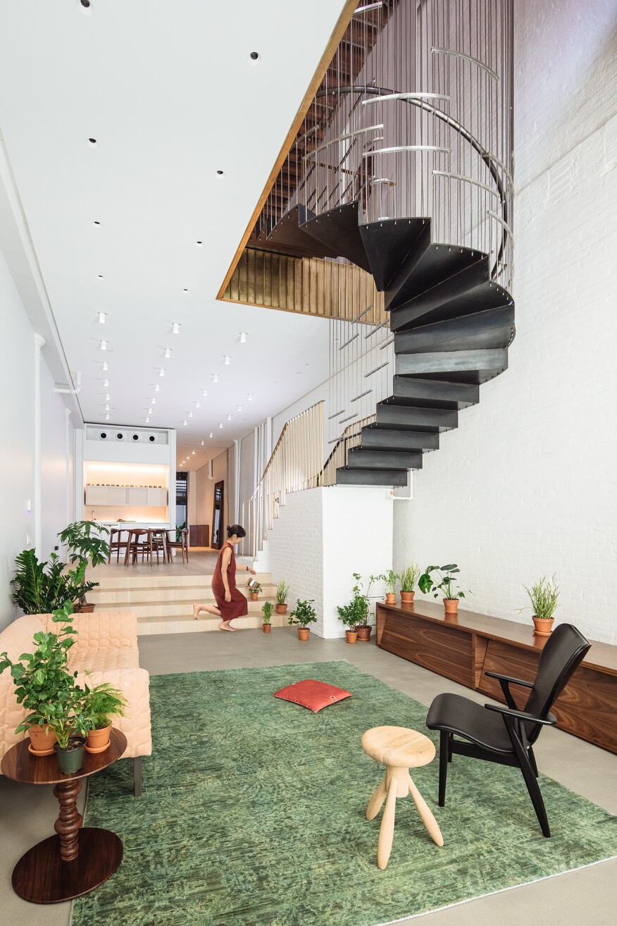 A suspended staircase helps to maximize floor space in the living room of the Raft Loft.