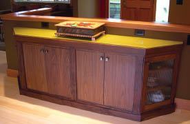 Walnut cabinets tie together the dining and cooking areas.