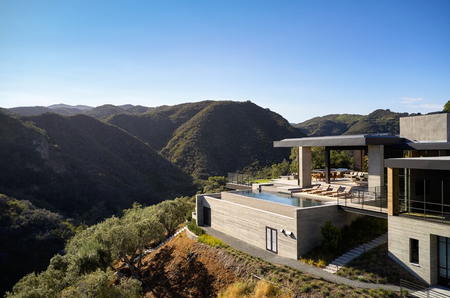 Situated on a promontory jutting into the canyon below, the hillside retreat boasts multiple vistas of the surrounding canyon and the Pacific Ocean beyond.