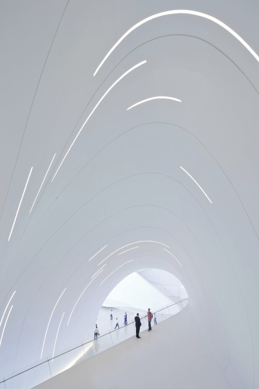 Within the center, slits along the interior's curved surfaces provide general illlumination while amplifying the vertiginous effect of the distorted spaces.
